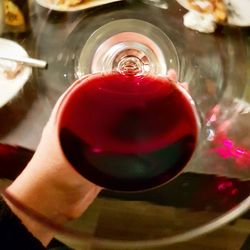 Close-up of hand holding glass of water