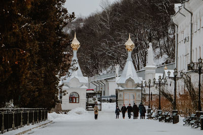 People in front of building during winter