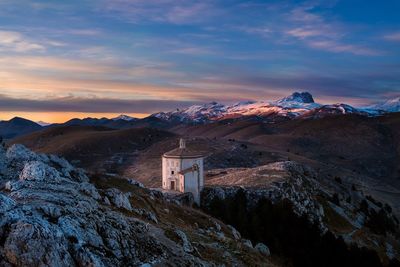 Scenic view of snowcapped mountains against sky during sunset