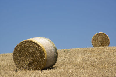 Two round bales of hay in the tuscan countryside