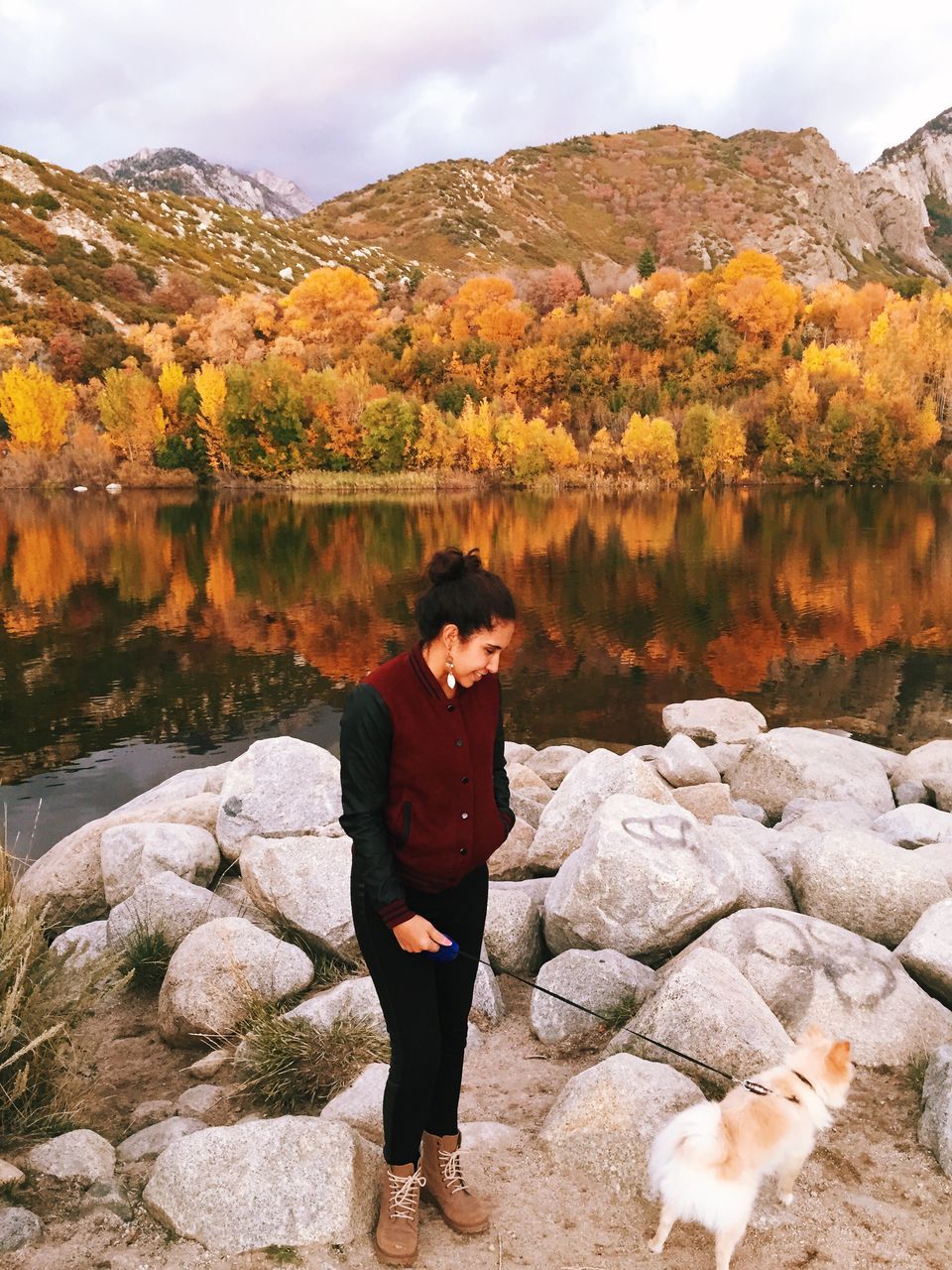 lifestyles, standing, leisure activity, rear view, full length, mountain, casual clothing, autumn, tranquility, sky, beauty in nature, rock - object, season, nature, scenics, tranquil scene, tree, water