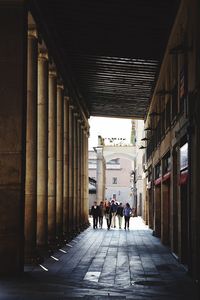 People walking in corridor of building