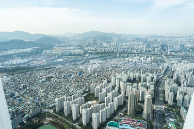 High angle view of modern buildings in city against sky