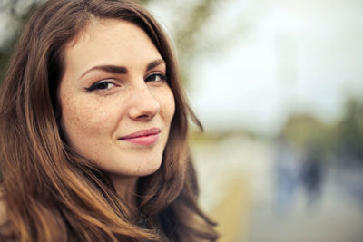 Close-up portrait of a smiling young woman