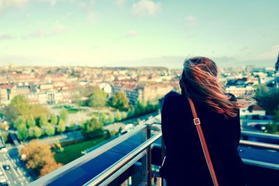 Rear view of woman looking at cityscape