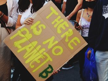 Midsection of woman holding poster