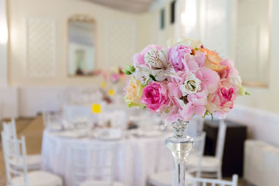 Close-up of pink flower vase on table at home