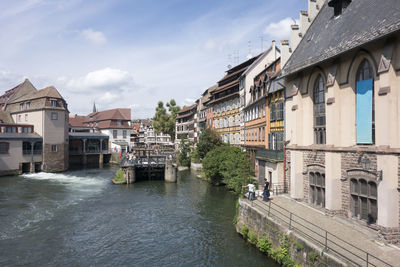 River amidst buildings against sky