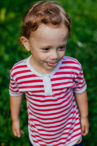 Portrait of cute boy standing outdoors