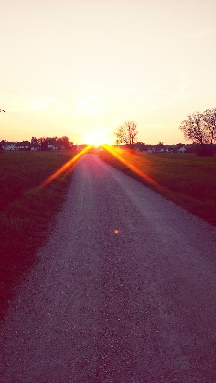 sunset, the way forward, sun, road, diminishing perspective, tranquil scene, vanishing point, landscape, sunlight, tranquility, transportation, sky, sunbeam, scenics, field, country road, lens flare, nature, clear sky, beauty in nature