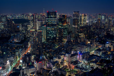 Aerial view of illuminated buildings in city at night