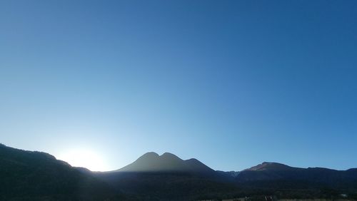 Scenic view of mountains against clear blue sky