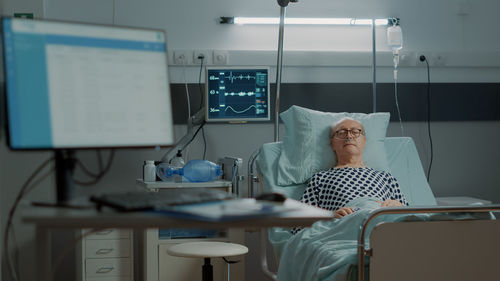 Senior man resting on bed in hospital