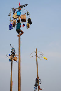 Low angle view of telephone pole against clear sky