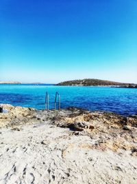 Scenic view of sea against clear blue sky