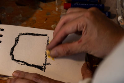 Cropped hand of person drawing