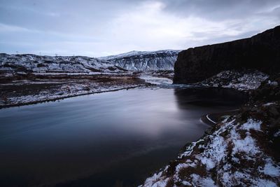 Scenic view of lake against sky during winter