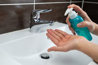 Midsection of woman in bathroom at home