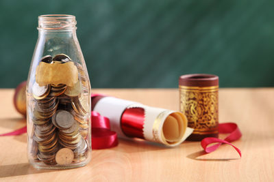 Close-up of document and coins on table