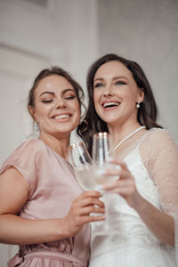 Portrait of a smiling young woman drinking glass