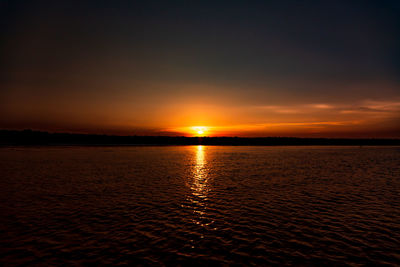 Scenic view of sea against romantic sky at sunset