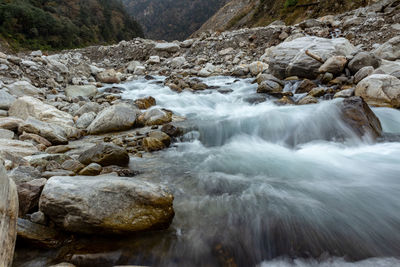 Scenic view of stream flowing through rocks