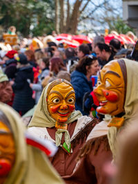 People wearing masks on road during parade