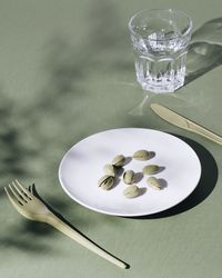 Close-up of pistachios in plate on table