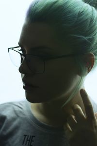 Close-up portrait of young woman with eyeglasses