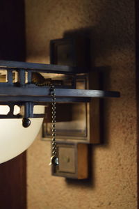 Close-up of electric lamp on wall