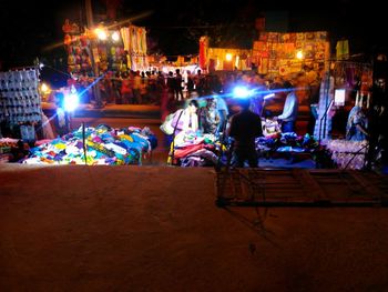 People in illuminated city at night