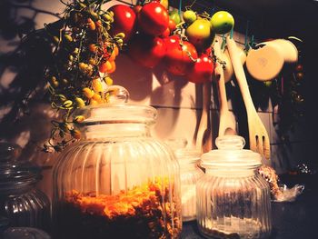 Close-up of flowering plants in glass jar on table