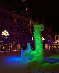 Illuminated buildings in city at night