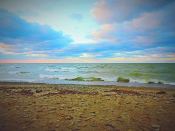 Scenic view of beach against sky during sunset