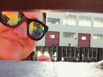 Close-up portrait of young woman in sunglasses