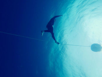 Low angle view of men swimming in sea