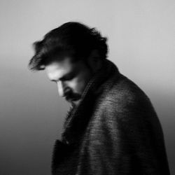 Side view of young man against white background