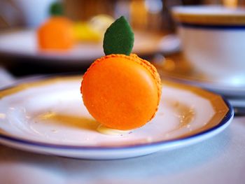 Close-up of oranges in plate on table