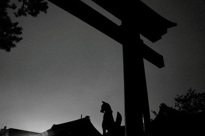 Low angle view of silhouette built structure against sky