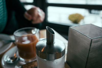 Close-up of container with coffee on table