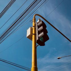 Low angle view of electricity pylon against sky