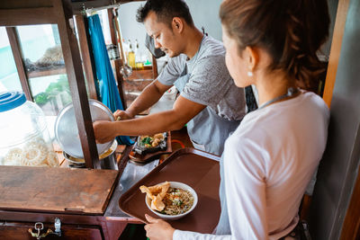 Side view of man preparing food at home