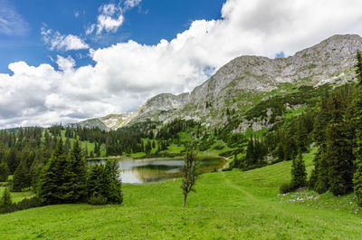 Scenic view of lake and mountains against sky