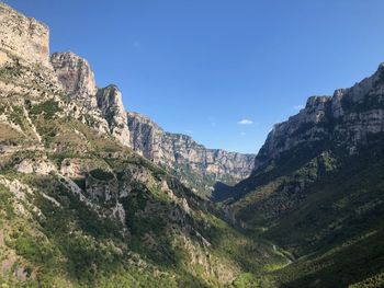 Scenic view of mountains against clear blue sky