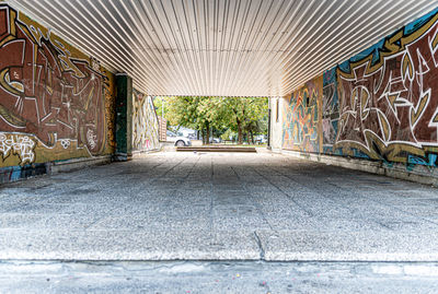 Empty road amidst buildings in city