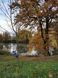 Man sitting on field during autumn