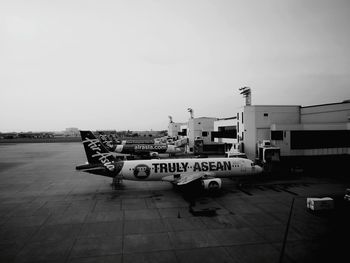 Airplane on airport runway against sky