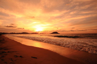 Scenic view of beach against sky during sunset