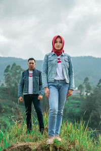 Portrait of young couple standing against beautifull mountain