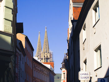 Low angle view of buildings against clear blue sky